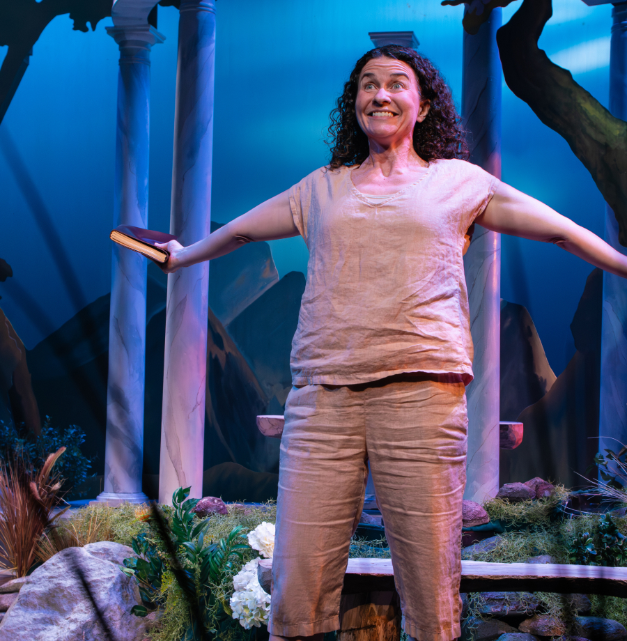 Mariah Sage on stage with outstretched arms